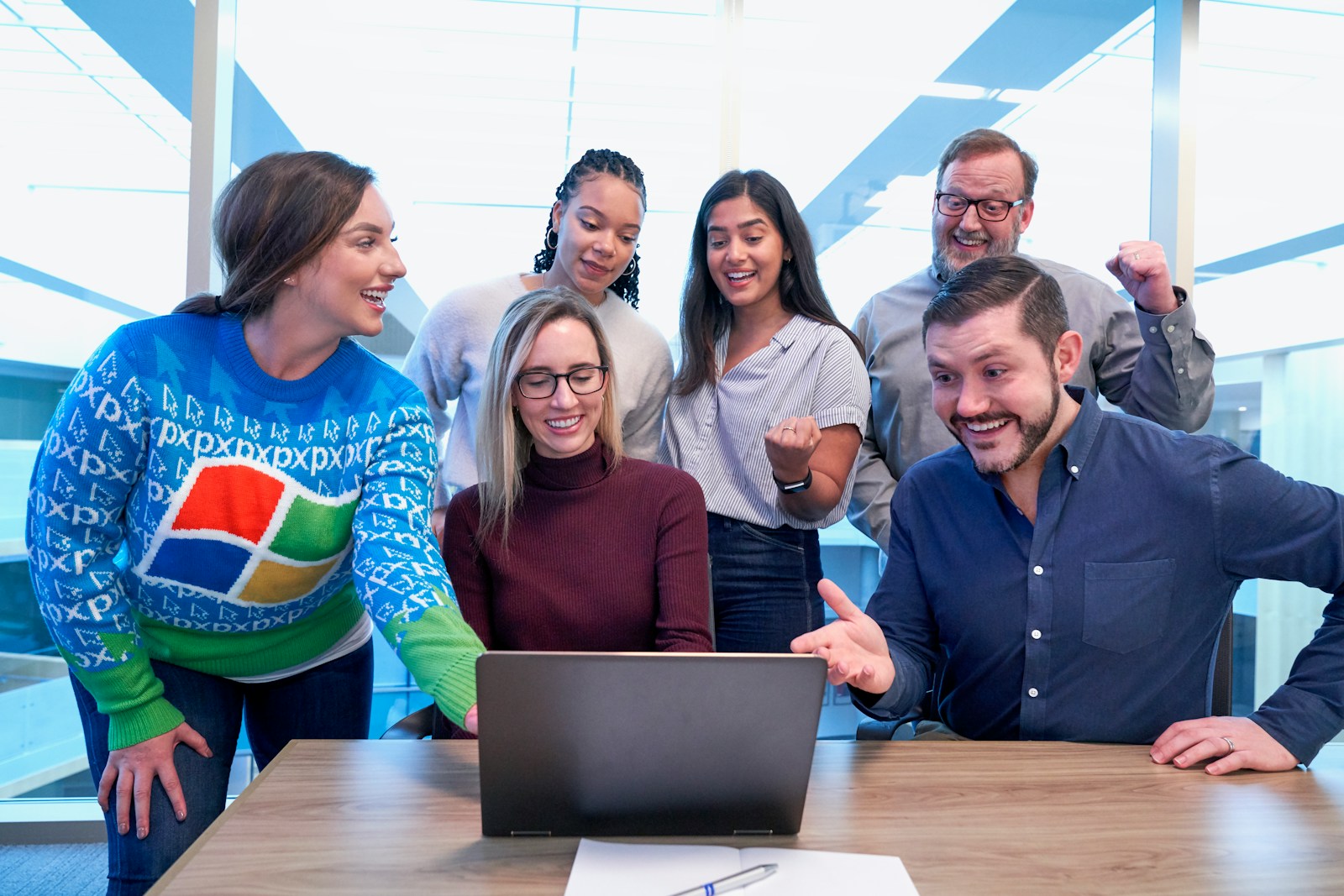 woman in maroon sweater using laptop, employee